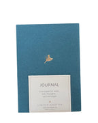 Blue journal with gold embossed design and label on a white background