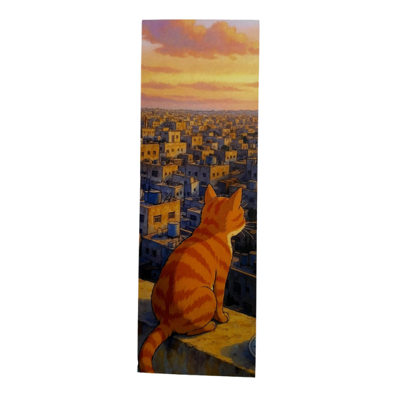 Cat sitting on a ledge overlooking a cityscape at sunset