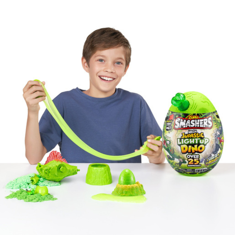 Child playing with a toy set including a 'Smashers' dinosaur egg and green slime.