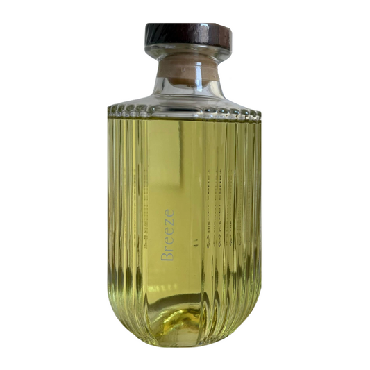 Clear glass bottle with a black cap on a white background