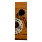 Coffee cup and saucer with floral design on a wooden surface