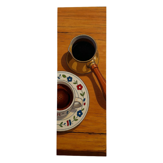 Coffee cup and saucer with floral design on a wooden surface