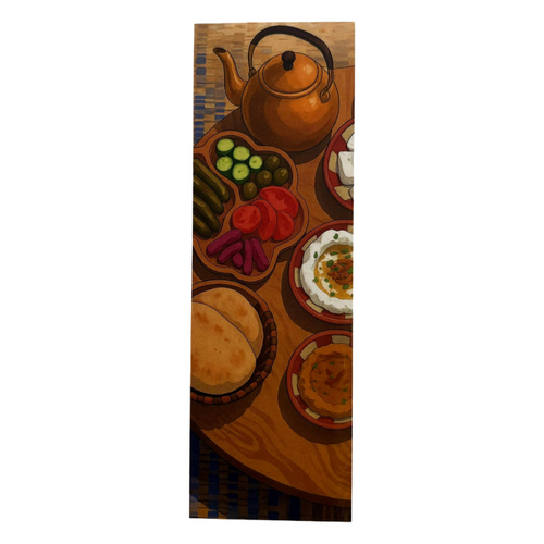 Decorative mat with a teapot, bread, and vegetables design on a wooden surface.