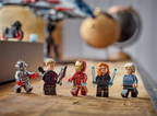 Five LEGO figures on a wooden surface with a blurred background