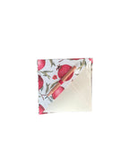 Folded fabric with pomegranate pattern on a white background