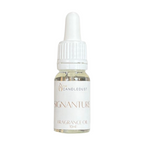 Fragrance oil bottle with dropper labeled 'Siganature' on a white background