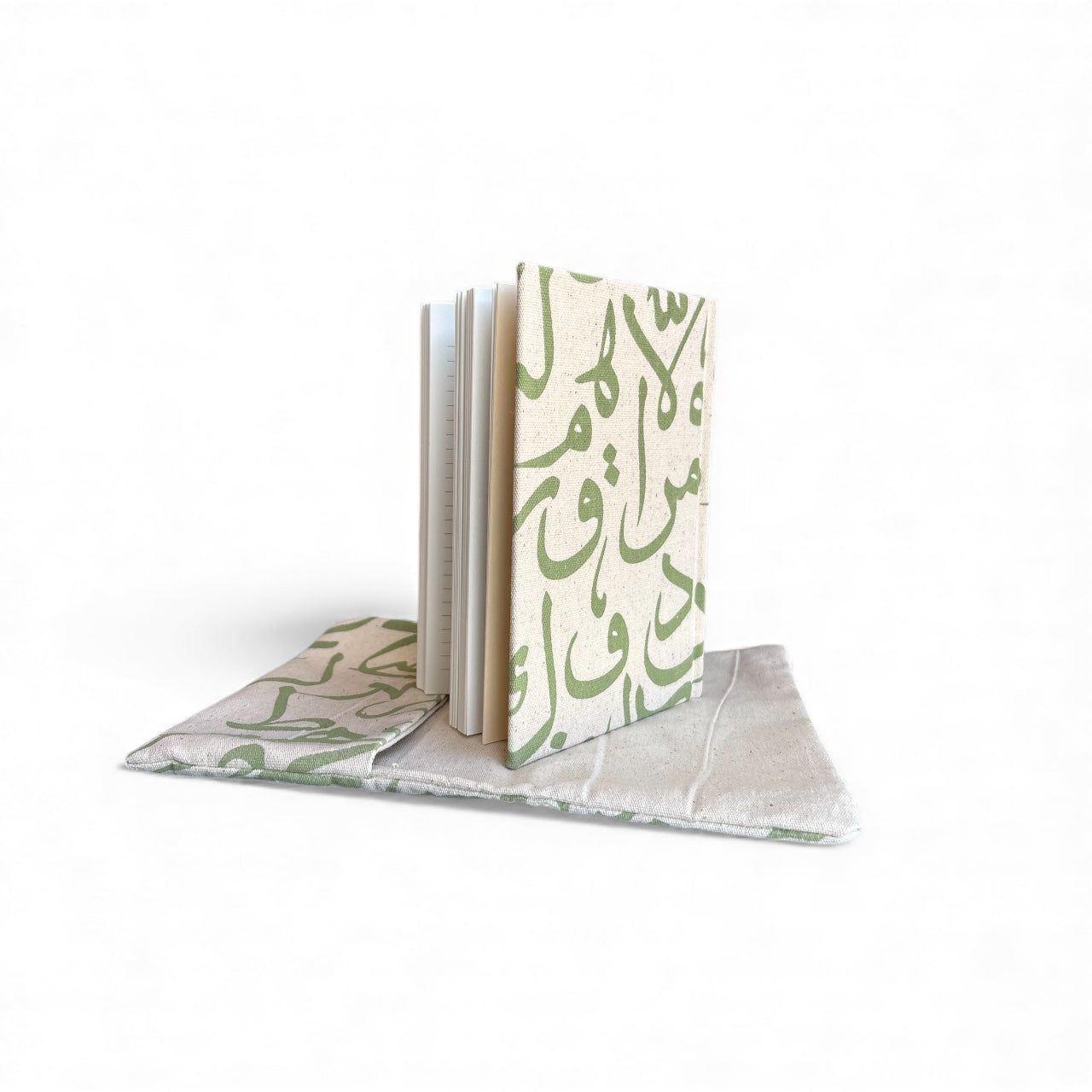 Notebook with green Arabic text on a white background