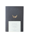 Journal with gold leaf design on a white background