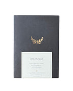 Journal with gold leaf design on a white background