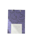 Painted pad with purple design and white label on a white background
