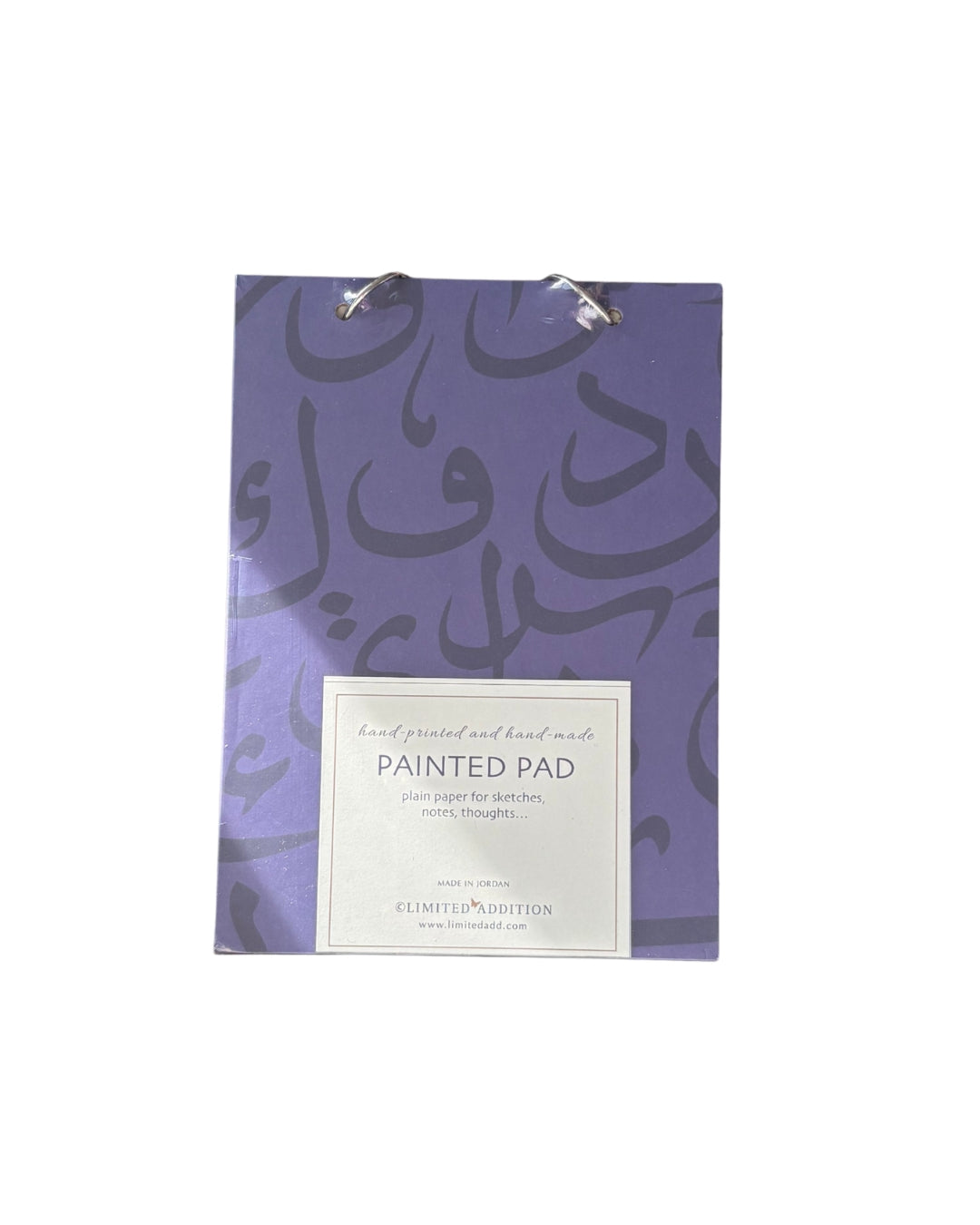 Painted pad with purple design and white label on a white background