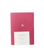 Pink journal with a gold emblem and label on a white background