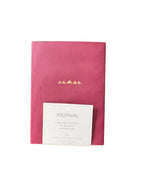 Pink journal with a white label on a white background