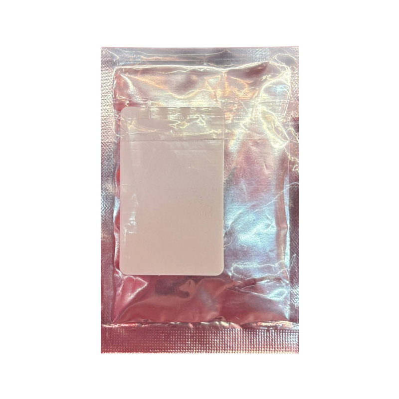 White bar of soap in a clear plastic bag on a white background