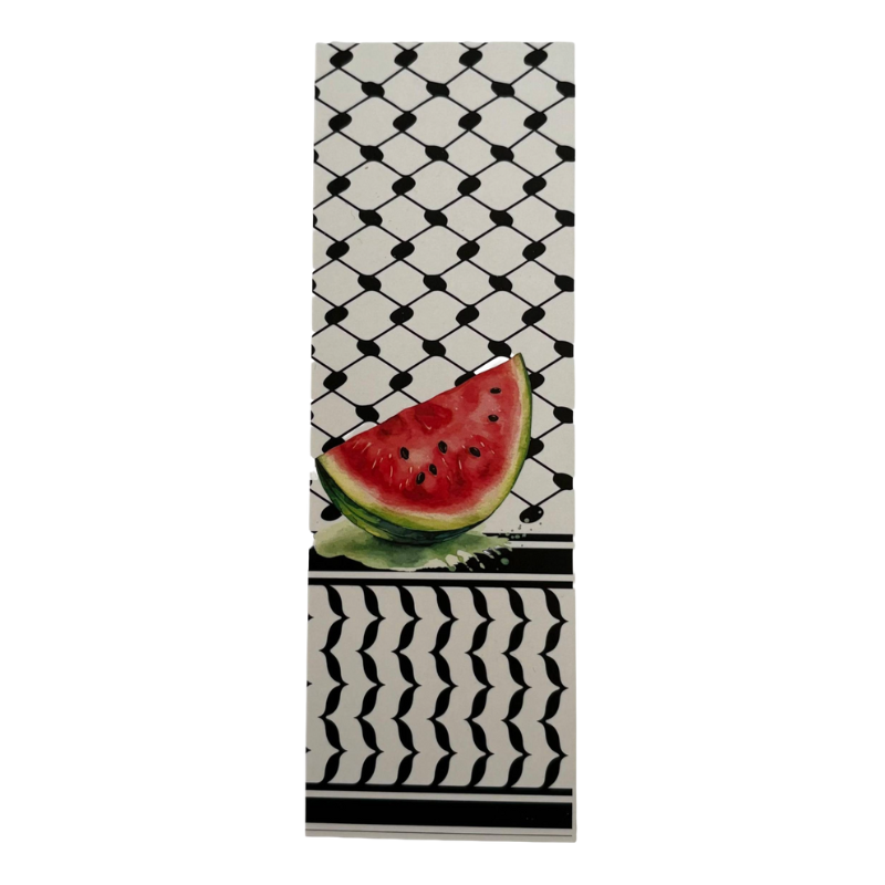 Towel with a watermelon slice design on a black and white patterned background